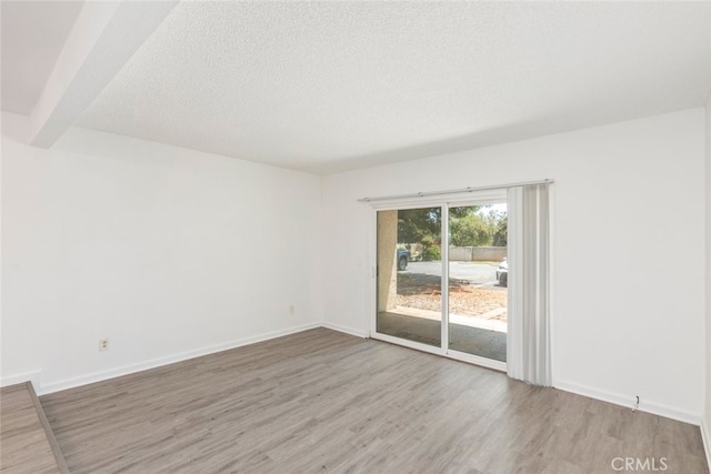 35104 Mesa Grande Dr, Calimesa, CA 92320 - unfurnished room with baseboards, wood finished floors, and a textured ceiling