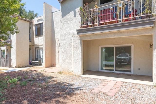 35104 Mesa Grande Dr, Calimesa, CA 92320 - rear view of house with stucco siding and a balcony