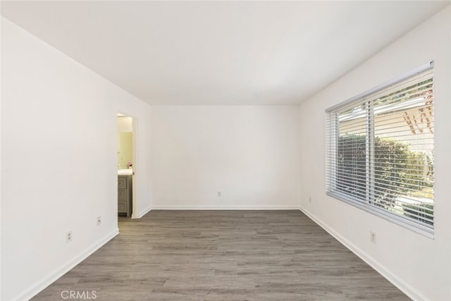 unfurnished room with dark wood-type flooring