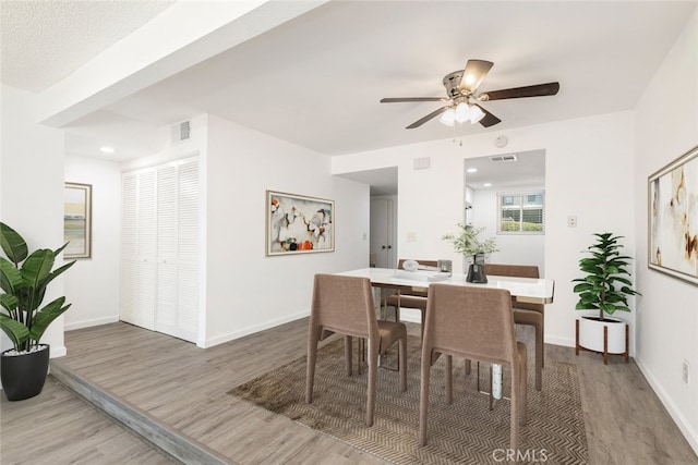 dining room with ceiling fan and hardwood / wood-style flooring