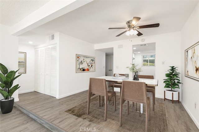 35104 Mesa Grande Dr, Calimesa, CA 92320 - dining area with wood finished floors, visible vents, a ceiling fan, and baseboards