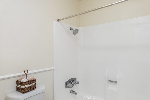 bathroom featuring  shower combination and toilet