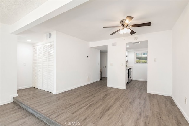 interior space with light hardwood / wood-style flooring and ceiling fan