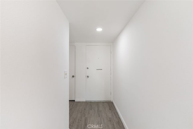 hallway with light hardwood / wood-style floors