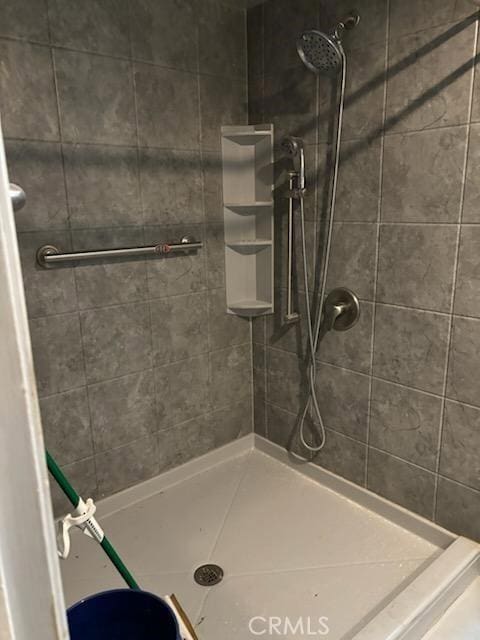 bathroom with tiled shower