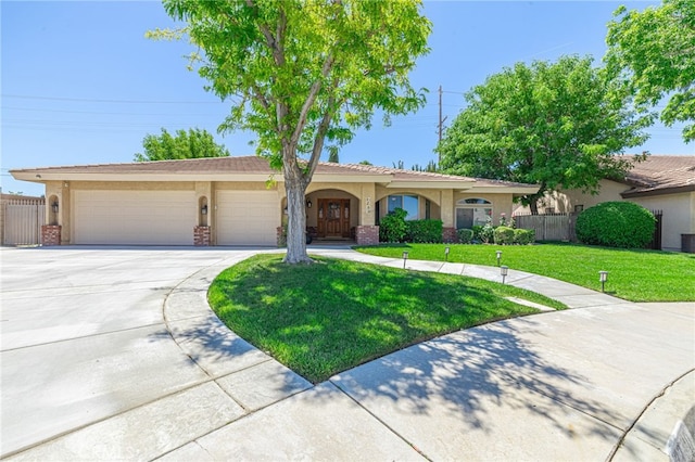 view of front of house featuring a garage and a front lawn