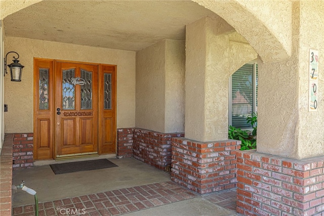 view of exterior entry featuring a porch