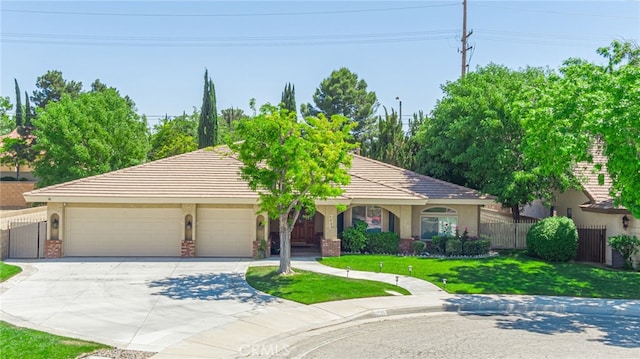 single story home with a garage and a front lawn