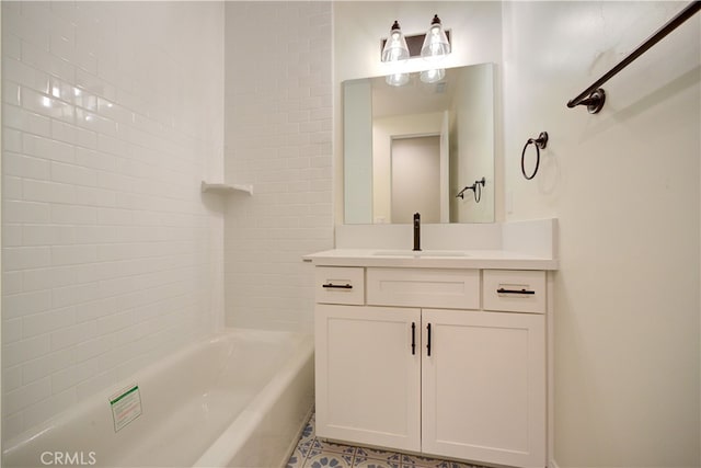 bathroom featuring vanity and tiled shower / bath