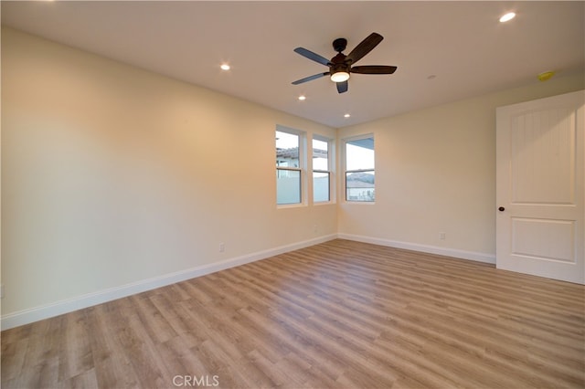 unfurnished room featuring ceiling fan and light hardwood / wood-style flooring