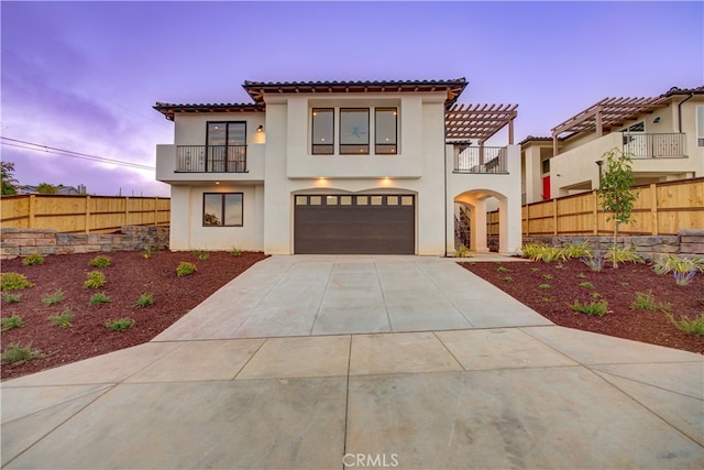 mediterranean / spanish-style home with a balcony and a garage