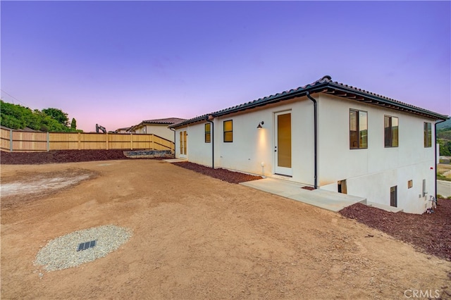 mediterranean / spanish house with a patio area