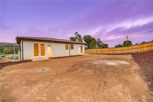 back house at dusk with french doors