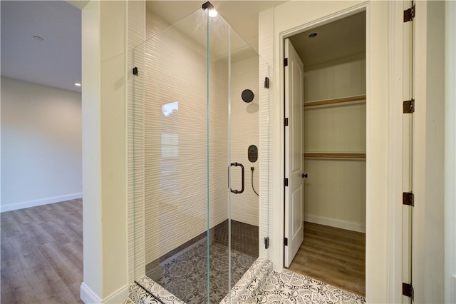 bathroom featuring hardwood / wood-style floors and an enclosed shower