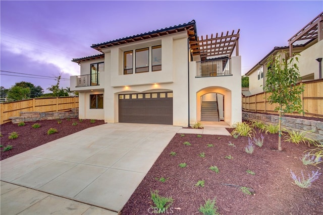 mediterranean / spanish-style house with a garage