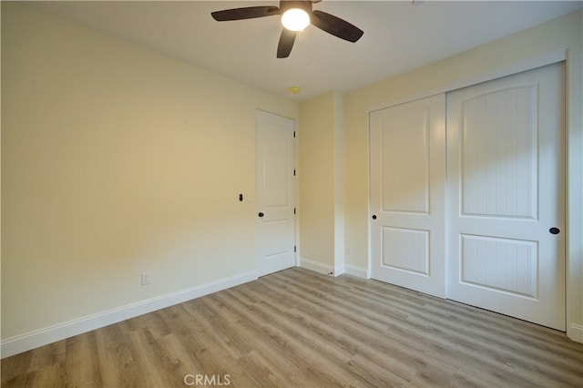 unfurnished bedroom with light hardwood / wood-style floors, a closet, and ceiling fan