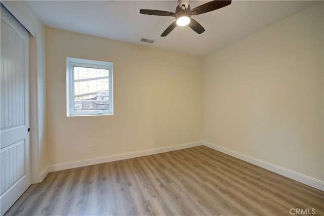 unfurnished bedroom with a closet, light wood-type flooring, and ceiling fan