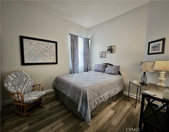 bedroom with dark wood-type flooring