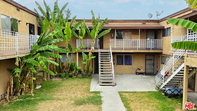 rear view of property with a patio area and a yard