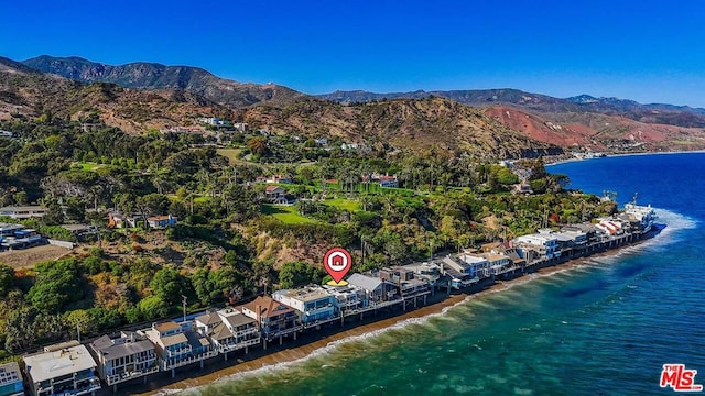 birds eye view of property with a water and mountain view