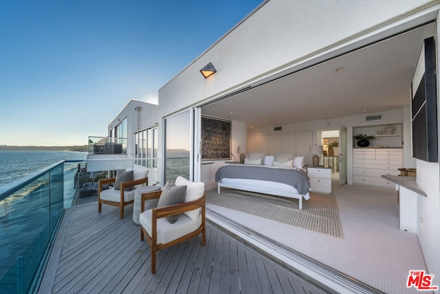 carpeted bedroom with a water view