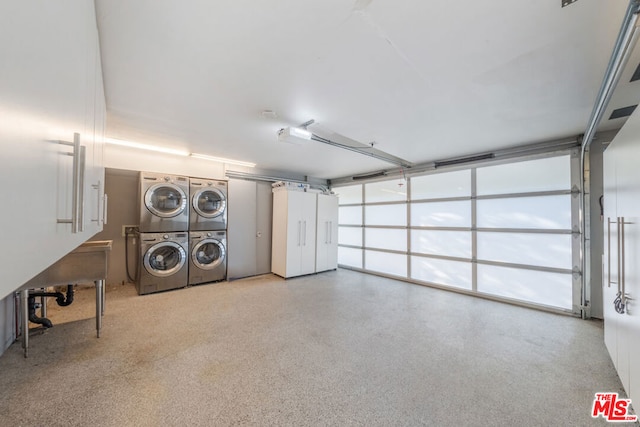 garage featuring stacked washer and clothes dryer and independent washer and dryer