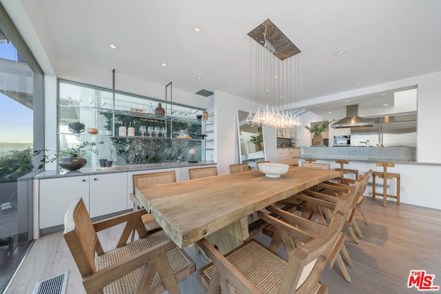 dining room featuring a healthy amount of sunlight and light wood-type flooring