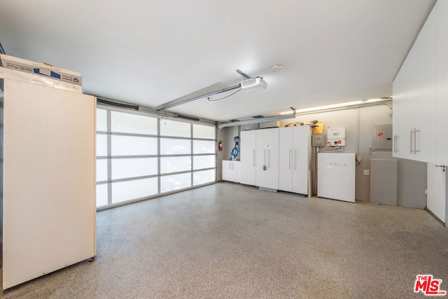 garage featuring a garage door opener and electric panel