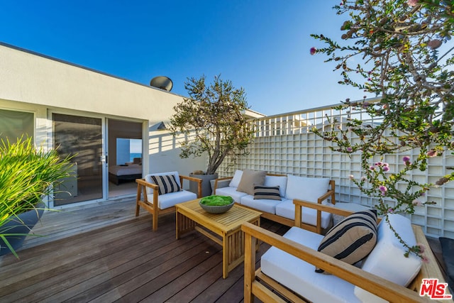 wooden deck with an outdoor living space