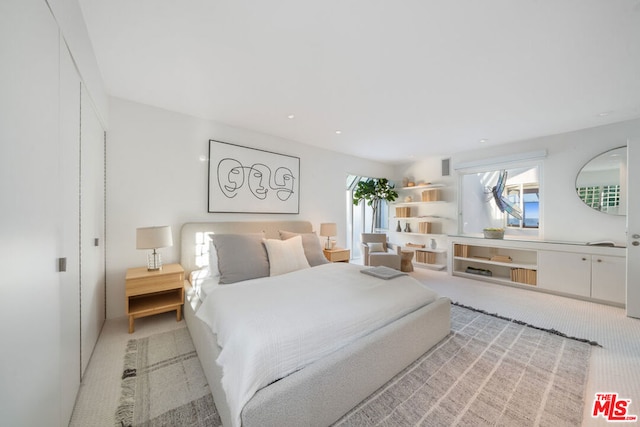 bedroom featuring light colored carpet