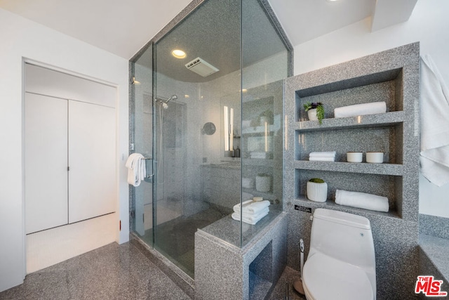 bathroom featuring toilet and an enclosed shower