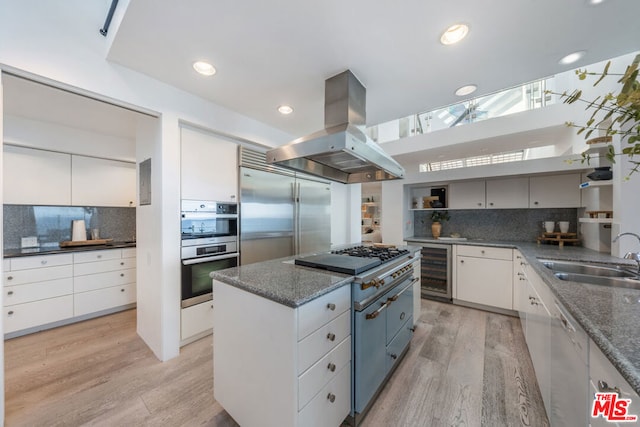 kitchen with island exhaust hood and white cabinets