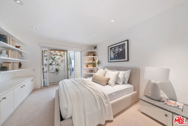 bedroom featuring access to exterior and light colored carpet