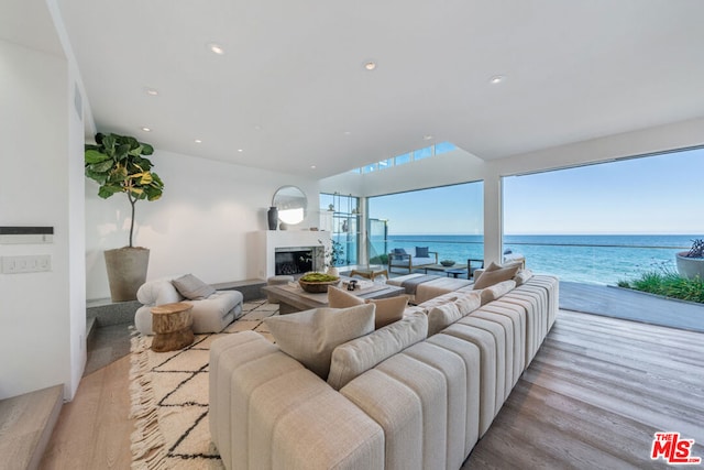 living room with a water view and light hardwood / wood-style floors