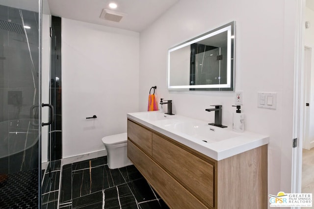 bathroom with walk in shower, vanity, and toilet