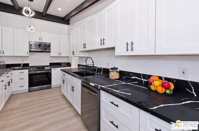 kitchen featuring white cabinets, sink, light hardwood / wood-style floors, beam ceiling, and stainless steel appliances