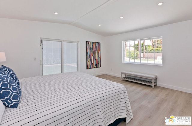 bedroom featuring access to exterior, light hardwood / wood-style floors, and vaulted ceiling