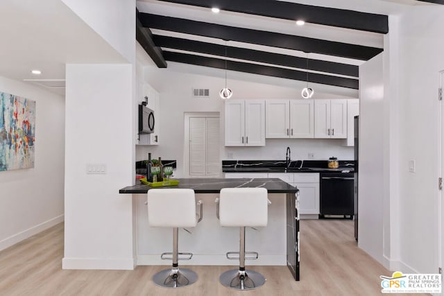 kitchen with sink, pendant lighting, black dishwasher, white cabinetry, and a breakfast bar area