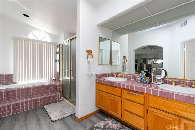 bathroom with vanity, shower with separate bathtub, and hardwood / wood-style floors