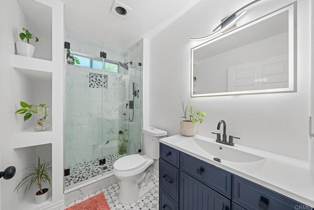 bathroom featuring an enclosed shower, vanity, and toilet