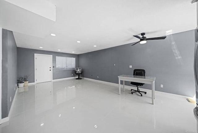 unfurnished office with ceiling fan and light tile patterned floors