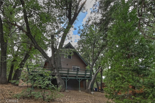 back of property featuring a wooden deck