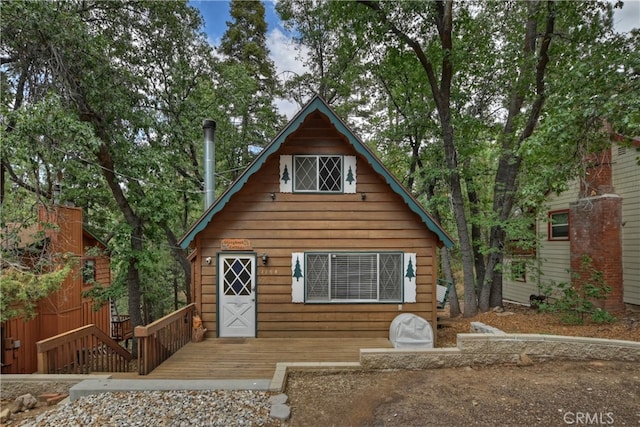 log cabin featuring a wooden deck