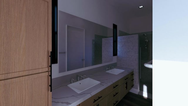 bathroom featuring walk in shower and vanity