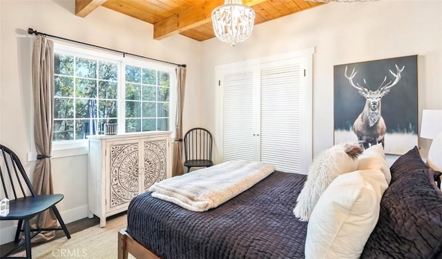 514 Emerald Dr, Lake Arrowhead, CA 92352 - bedroom featuring wooden ceiling with exposed beams, a chandelier, baseboards, light wood-style flooring, and a closet
