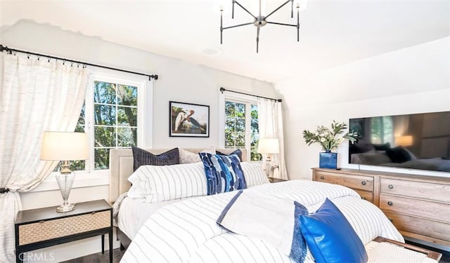 514 Emerald Dr, Lake Arrowhead, CA 92352 - bedroom featuring multiple windows, a chandelier, lofted ceiling, and wood finished floors