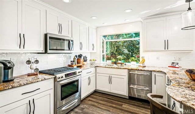 514 Emerald Dr, Lake Arrowhead, CA 92352 - kitchen with stainless steel appliances, white cabinets, dark wood finished floors, tasteful backsplash, and light stone counters