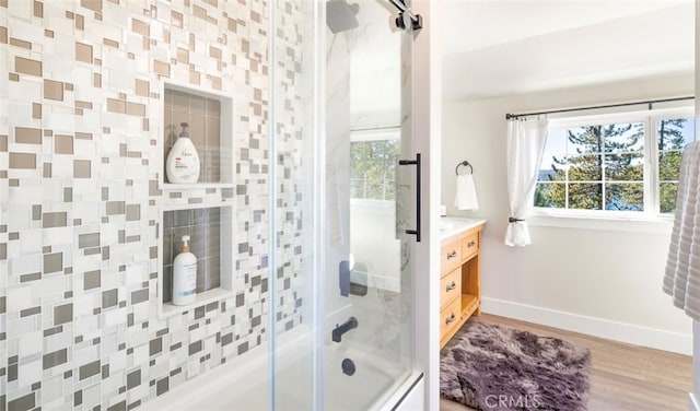 bathroom featuring shower / bath combination with glass door, vanity, and hardwood / wood-style floors