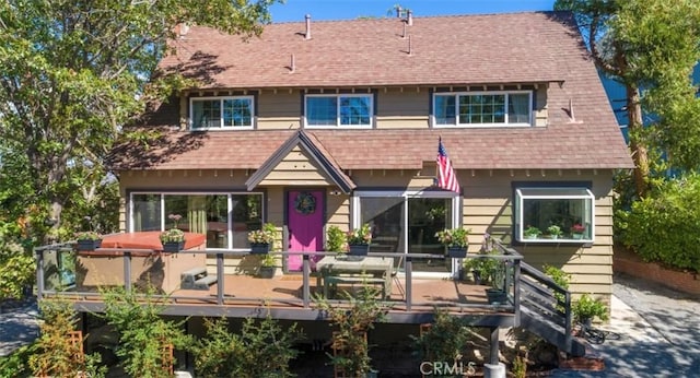 514 Emerald Dr, Lake Arrowhead, CA 92352 - back of property with a shingled roof, a deck, and a hot tub