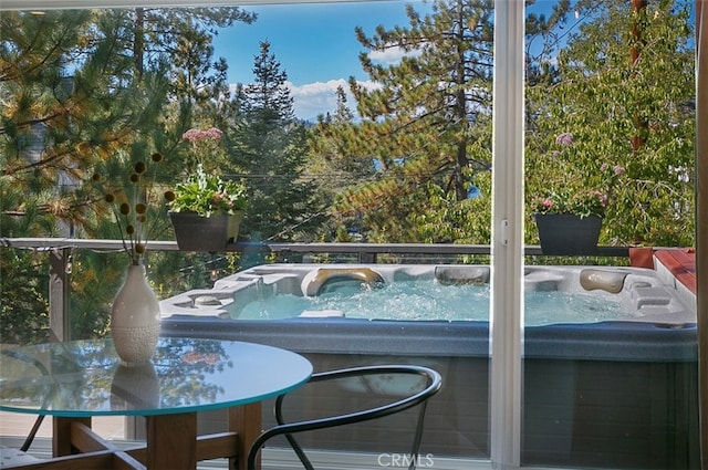 view of swimming pool featuring a hot tub